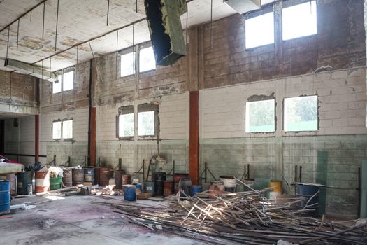 Interior of an abandoned cellar with details of wear and tear by time. You can see flashes of sunlight that enter through gaps and windows.