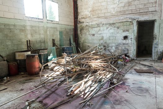 Interior of an abandoned cellar with details of wear and tear by time. You can see flashes of sunlight that enter through gaps and windows.