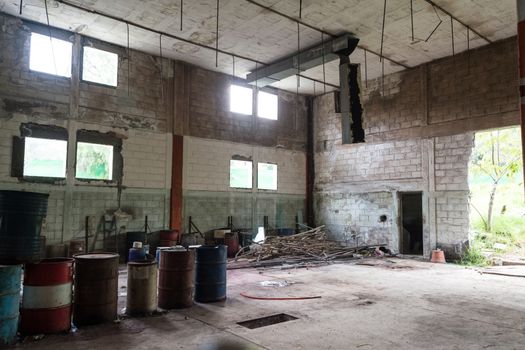 interior of an abandoned cellar with details of wear and tear by time. you can see flashes of sunlight that enter through gaps and windows.
