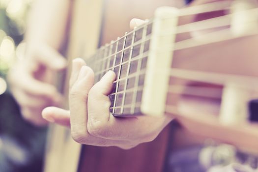 Close up image of Man playing his guitar Background