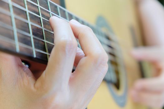 Close up image of Man playing his acoustic guitar Background