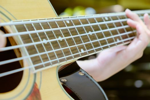 Close up image of Man playing his acoustic guitar Background