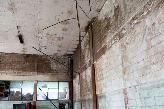 interior of an abandoned cellar with details of wear and tear by time. you can see flashes of sunlight that enter through gaps and windows.