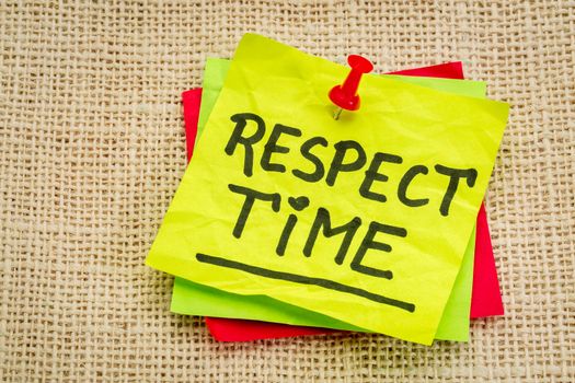 respect time reminder - handwriting on a sticky note against burlap canvas
