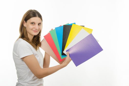 Young beautiful girl holding a picture with solid colors