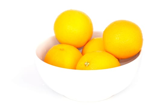 Orange fruit in white bowl on white background .