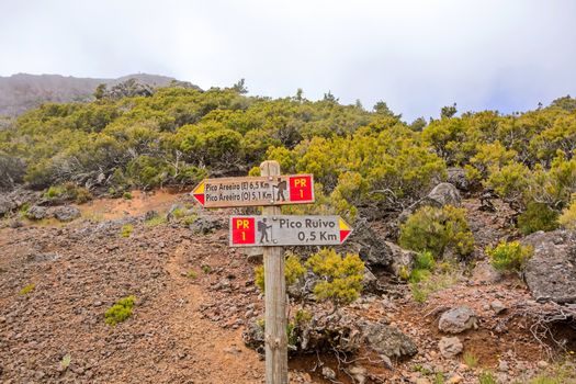 Hiking trail passage from mountain Pico Areeiro to Pico Ruivo, Madeira - signpost showing the routes