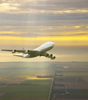 Airplane flying in beautiful yellow sky