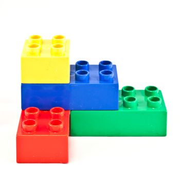 Plastic building blocks on white background. Bright colors.