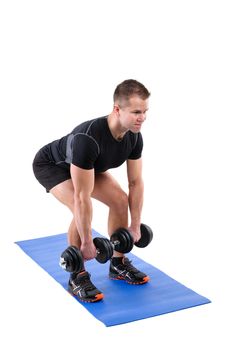 Young man shows finishing position of Squats with dumbbels workout, isolated on white