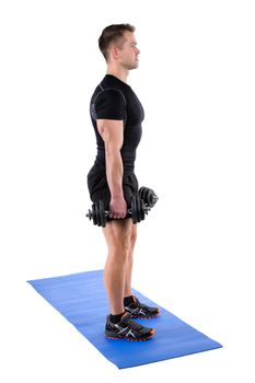 Young man shows starting position of both Standing Dumbbell Calf Raise with Dumbbels or Squats workout, isolated on white