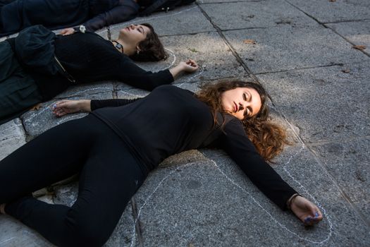 SPAIN, Madrid: Demonstrators participate in a die-in as thousands of protesters from across Spain march through Madrid on November 7, 2015 in a rally against gender violence. In Spain, more than 1,390 women have reportedly been murdered by male attackers since 1995; this year, 84 cases involving the murder of women by men have been reported thus far. 