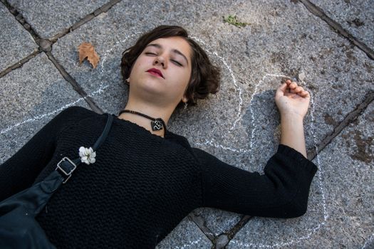 SPAIN, Madrid: A demonstrators participates in a die-in as thousands of protesters from across Spain march through Madrid on November 7, 2015 in a rally against gender violence. In Spain, more than 1,390 women have reportedly been murdered by male attackers since 1995; this year, 84 cases involving the murder of women by men have been reported thus far. 