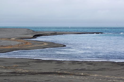 Coast and beach with black volcano sand in Iceland