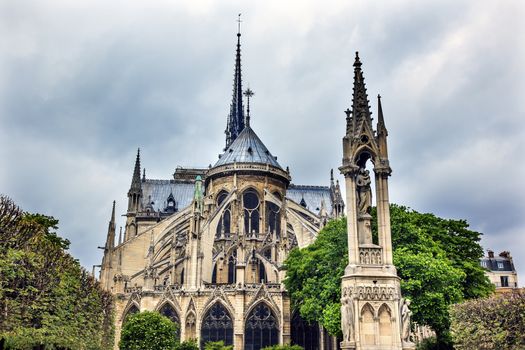 Rear Back Overcast Skies Flying Buttresses Notre Dame Cathedral Paris France.  Notre Dame was built between 1163 and 1250AD.  