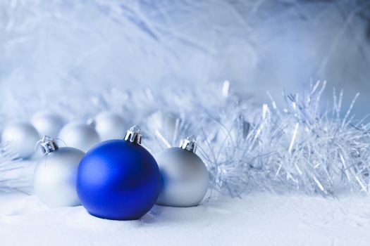 Blue Christmas balls on the white snow