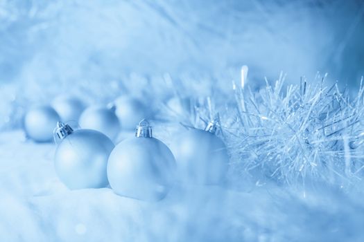 Blue Christmas balls on the white snow