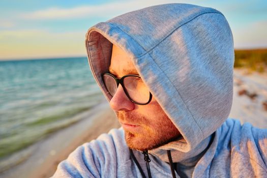 Handsome man with glasses making selfie and smiling