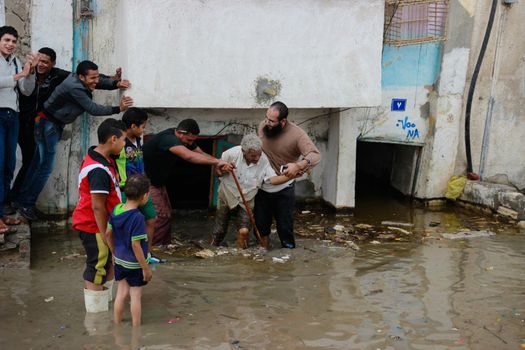 EGYPT, Alexandria: People are seen in the flooding road after a torrential rain caused flood in the Kafr El Arab neigborhood in west of Alexandria, Egypt on November 07, 2015.