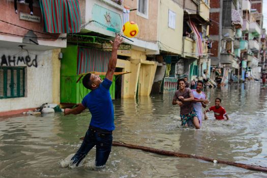 EGYPT, Alexandria: People are seen in the flooding road after a torrential rain caused flood in the Kafr El Arab neigborhood in west of Alexandria, Egypt on November 07, 2015.