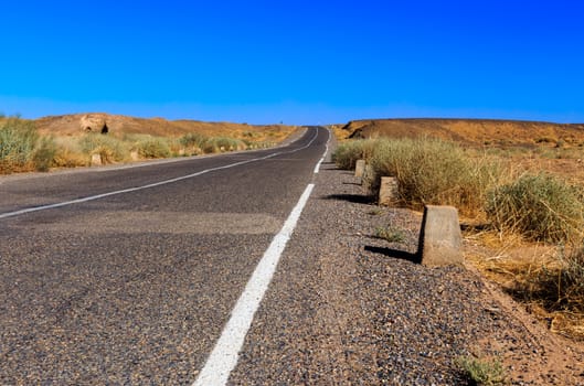 asphalt road in the Sahara desert, Morocco