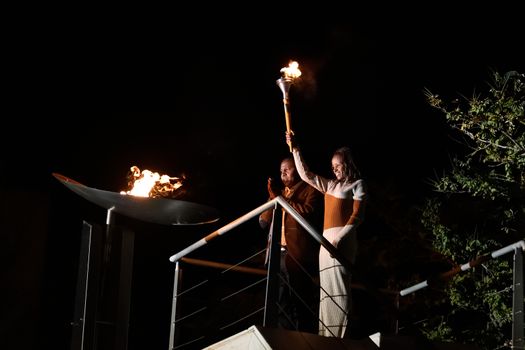 GREECE, Athens: Mare Dibaba, winner of the 2015 marathon at the world championships in Beijing, lights the altar during the Ceremony of the Lighting of the Marathon Flame at the Marathon Tomb in Athens, Greece, on November 7, 2015.