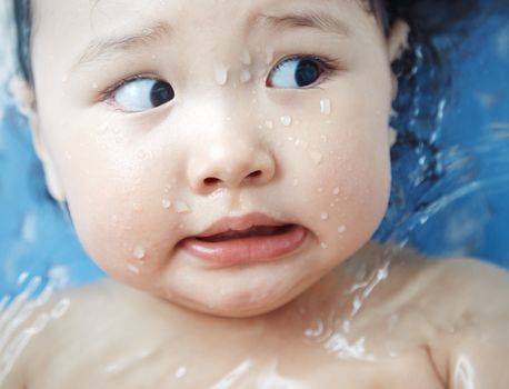 Afraid child in the bath. Close-up horizontal photo