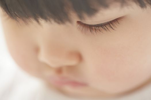 Close-up photo of pensive child looking down