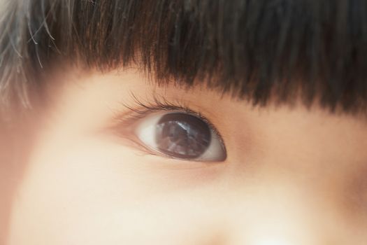 Close-up photo of pensive child looking up