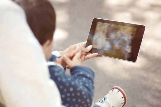 Mother and child making self-photo by digital tablet