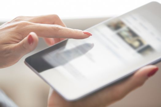 Hands of woman using digital tablet