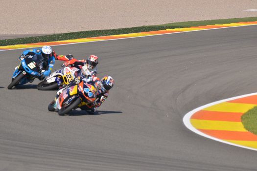 SPAIN, Cheste: Italian pilot Niccolo Antonelli (C) falls during Valencia Motor GP tournament at Ricardo Tormo circuit in Valencia, Spain on November 8, 2015.Miguel Oliveira won the race and Danny Kent took Moto3 title.