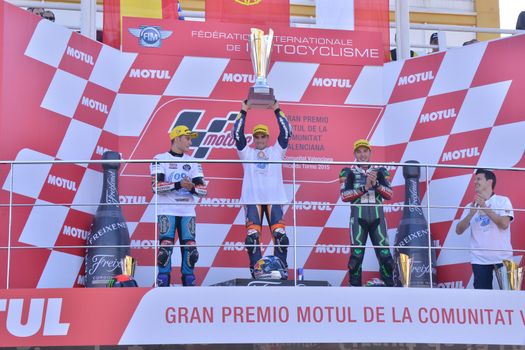 SPAIN, Cheste: Red Bull KTM Ajo's Portugese rider Miguel Oliveira (C), Sepang International Circuit's Czech rider Jakub Kornfeil (L) and Estrella Galicia 0,0's Sapnish rider Jorge Navarro celebrate on the podium after the Moto3 race at the Valencia Grand Prix at Ricardo Tormo racetrack in Cheste, near Valencia on November 8, 2015.