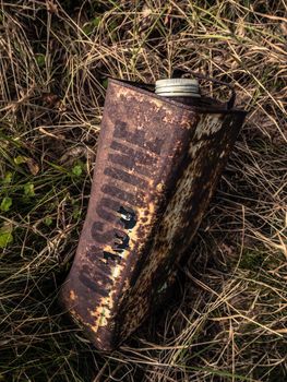 Conceptual Image Of An Old Rusty Gasoline Can Abandoned In The Undergrowth
