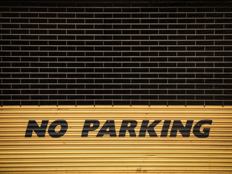 Grungy Urban No Parking Sign On Yellow Shutters