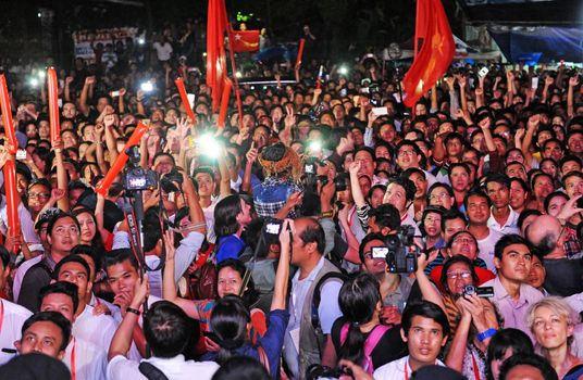 MYANMAR, Yangon: Supporters of Myanmar opposition leader Aung San Suu Kyi's party cheer as they watch a polling station counts on a giant screen outside the party headquarters in Yangon on November 8, 2015. Myanmar goes to the polls in an historic election that could thrust opposition leader Aung San Suu Kyi's pro-democracy party into power and pull the country away from the grip of the military. 