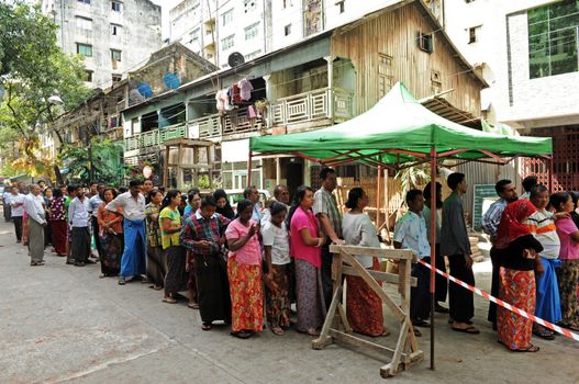 MYANMAR, Yangon: Voters line up in front of a polling station in Yangon, Myanmar, on November 8, 2015. Myanmar goes to the polls in an historic election that could thrust opposition leader Aung San Suu Kyi's pro-democracy party into power and pull the country away from the grip of the military. 