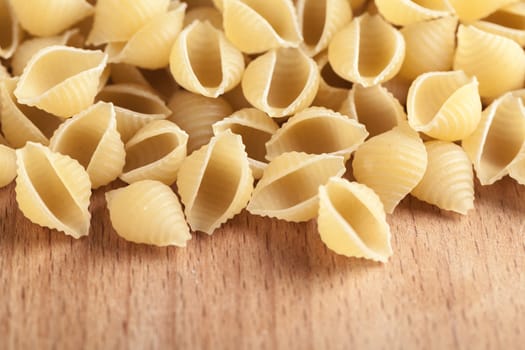 raw the pasta closeup on wooden background 
