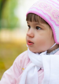 portrait of a little girl playing outdoors in autumn