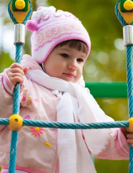 portrait of a little girl playing outdoors in autumn