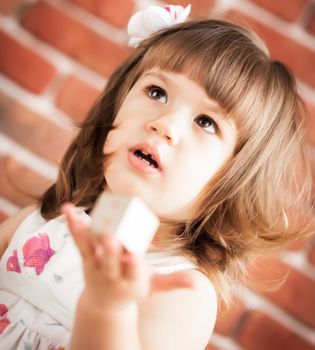 baby girl holding the a toy in her hand