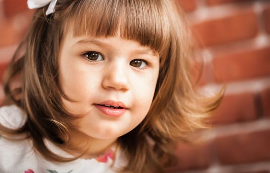 portrait of a baby on the background brick wall