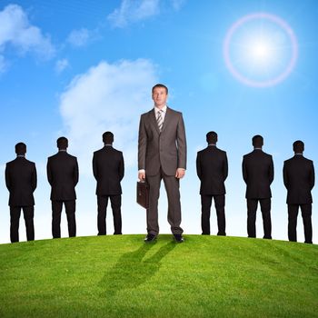 Set of businessmen on nature background with green grass and blue sky