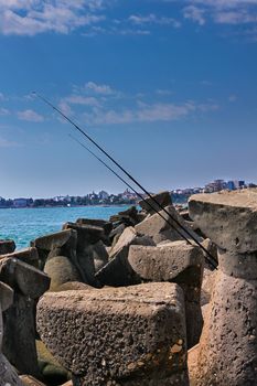 Two fishing rod on the concrete structures at Constanta shore