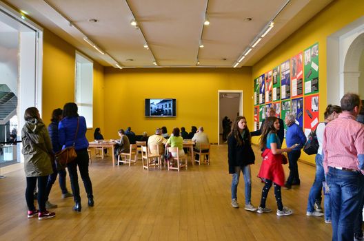 Amsterdam, Netherlands - May 6, 2015: People visit Stedelijk Museum in Amsterdam located in the museum park, Netherlands on May 6, 2015.