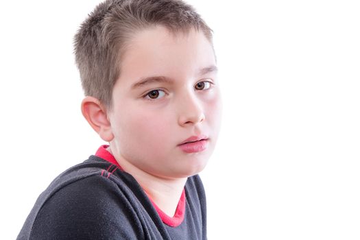 Head and Shoulders Close Up Portrait of Young Boy Wearing Black and Red Shirt Staring Blankly at Camera in Studio with White Background and Copy Space