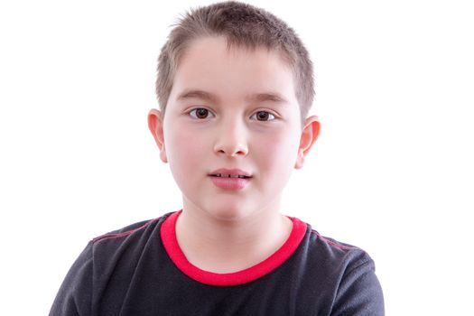 Head and Shoulders Close Up Portrait of Young Boy Looking at Camera with Blank Expression in front of White Studio Background