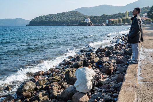 GREECE, Lesbos: The northern coast of the Greek island of Lesbos is covered with thousands of orange life jackets on November 8, 2015. A fresh group of refugees arrive under the supervision of the Greek and Turkish coast guards.  