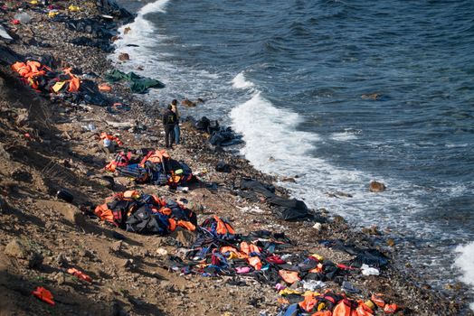 GREECE, Lesbos: The northern coast of the Greek island of Lesbos is covered with thousands of orange life jackets on November 8, 2015. A fresh group of refugees arrive under the supervision of the Greek and Turkish coast guards.  
