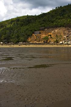 house cabin  people  river   palm  rock stone branch hill lagoon and coastline in madagascar nosy be
